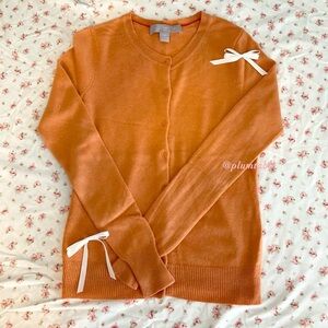 Chic Orange Cardigan with White Bow Accents